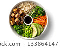 A vegan bowl features rice, tofu, broccoli, avocado, edamame, and carrots. 133864147