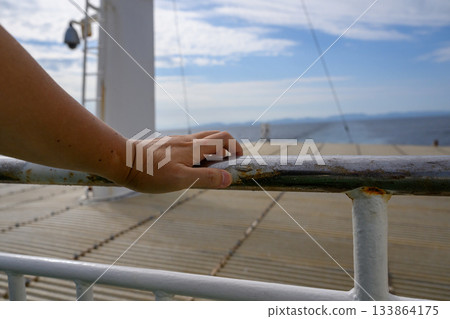 Handrail and ship at sea Handrail and ship at sea 133864175