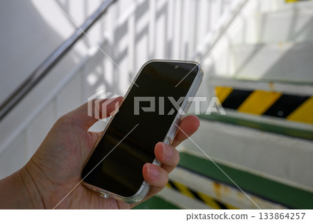 Hands with smartphone 133864257
