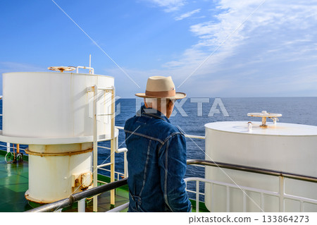 Man looking at the sea from a boat 133864273