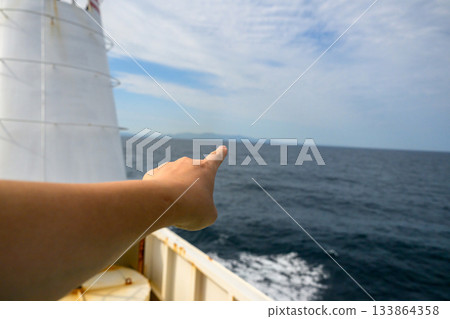 Pointing out the sea and islands from the ferry heading to Oki Island 133864358
