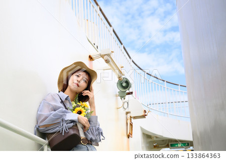 Woman with straw hat and flowers Woman with straw hat and flowers 133864363