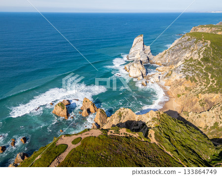 Cabo da Roca, Ursa Beach, Cliffs and Atlantic Ocean Waves on Sunny Day. Aerial View. Portugal Cabo da Roca, Ursa Beach, Cliffs and Atlantic Ocean Waves on Sunny Day. Aerial View. Portugal 133864749