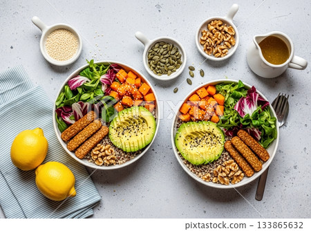 Two Vibrant Vegan Power Bowls with Quinoa, Avocado, Tempeh, Sweet Potato, and Fresh Greens 133865632