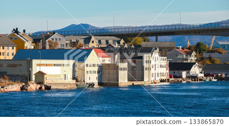 Warehouses and docks along the calm harbor of Kristiansund, Norway 133865870
