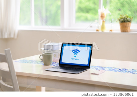 A bright room with a laptop displaying free Wi-Fi A bright room with a laptop displaying free Wi-Fi 133866061