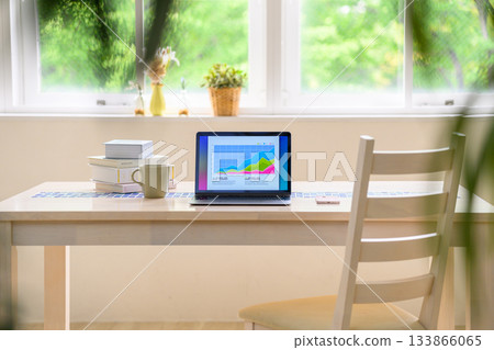 Close-up of a desk and laptop by the window 133866065