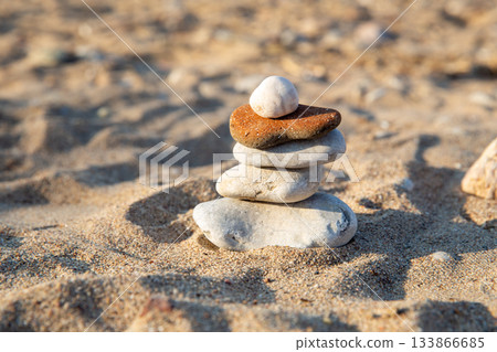 Zen-like stones on Frencch riviera several beach stones one on other- maintaining mental and physical balance Zen-like stones on Frencch riviera several beach stones one on other- maintaining mental and physical balance 133866685