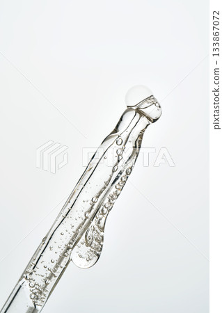 Cosmetic pipette dropping liquid serum with bubbles 133867072