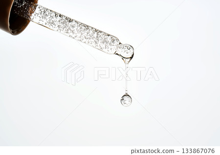 Cosmetic pipette dropping liquid serum with bubbles Cosmetic pipette dropping liquid serum with bubbles 133867076