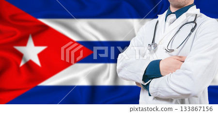 Cuba healthcare concept. Male doctor on Cuban flag. Doctor with crossed arms on Cuba flag 133867156