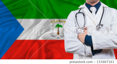 Male doctor with stethoscope on Equatorial Guinea flag. Doctor holding stethoscope on Equatorial Guinea flag Male doctor with stethoscope on Equatorial Guinea flag. Doctor holding stethoscope on Equatorial Guinea flag 133867161