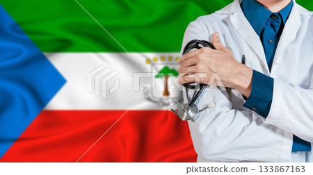 Equatorial Guinea healthcare concept. Doctor with stethoscope on Equatorial Guinea flag. Doctor holding stethoscope on Equatorial Guinean flag Equatorial Guinea healthcare concept. Doctor with stethoscope on Equatorial Guinea flag. Doctor holding stethoscope on Equatorial Guinean flag 133867163