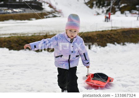 A girl with snow bob climbs a mountains A girl with snow bob climbs a mountains 133867324