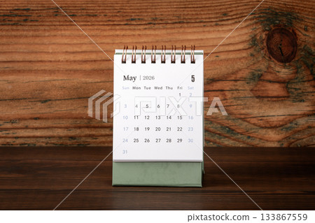 May 2026 Desk Calendar on Wooden Background Surface 133867559