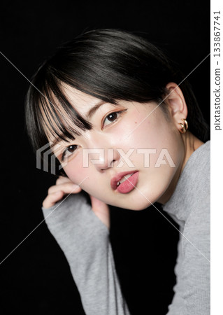 Beautiful woman's gaze on black background 133867741