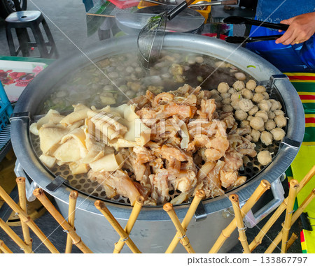 The image shows a street food stall preparing Bakso, a popular Indonesian meatball soup. 133867797