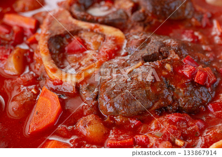 ossobuco stew with vegetables, knuckle on the bone with new potatoes, in tomato sauce,homemade, top view, no people, 133867914