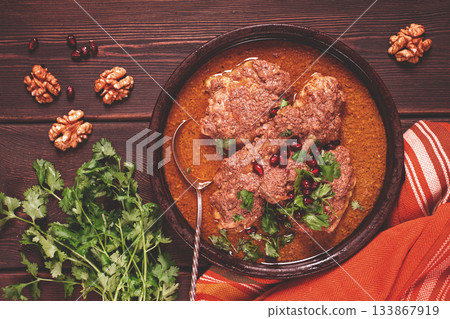 fesenjan, an Iranian dish, stewed chicken, in walnut-pomegranate sauce, in an earthen pan, homemade, no people, 133867919