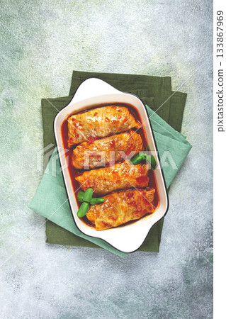 Stuffed cabbage rolls with minced meat, in tomato sauce, top view, without people, in the spotlight. 133867969