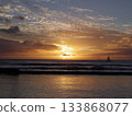 Sunset and golden ripples on the seaside with a yacht floating 133868077