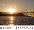 A dramatic scene created by the golden sea and the sunset over the mountains 133868083