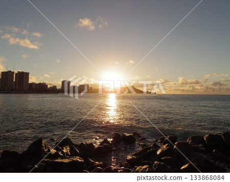 Sunset light trails seen through the rocks and Diamond Head in the distance Sunset light trails seen through the rocks and Diamond Head in the distance 133868084