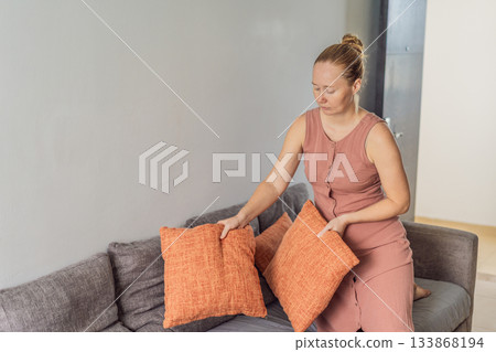 Woman relaxing at home and watching a movie on the television, enjoying a peaceful evening atmosphere. Cozy lifestyle, leisure and entertainment concept, representing comfort, calmness and modern home 133868194