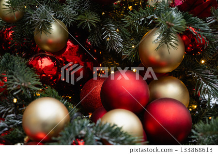 Christmas tree decorated red balls and lights garland. Xmas holiday spirit. Winter. Outdoors. 133868613