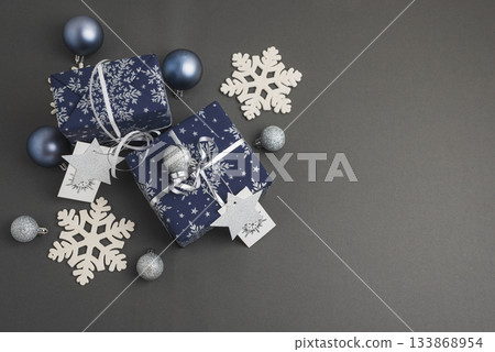 Blue Christmas Gift Boxes with Silver Ribbons and Snowflake Decorations Blue Christmas Gift Boxes with Silver Ribbons and Snowflake Decorations 133868954