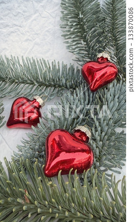Red Christmas Ornaments on Fresh Pine and Fir Branches 133870086