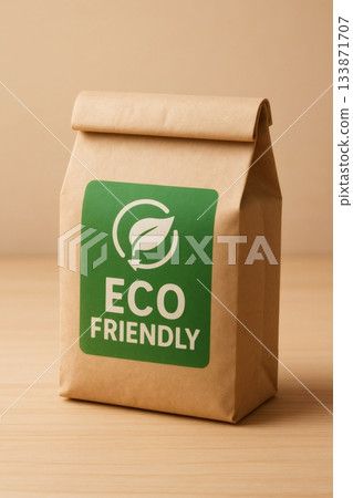 Brown paper bag displaying an eco friendly label with a recycling logo and text, promoting sustainable packaging 133871707