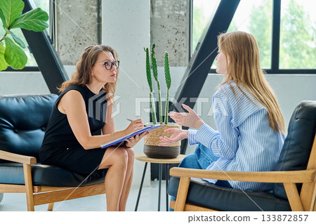 Mental therapy session, female professional psychologist working with young woman patient Mental therapy session, female professional psychologist working with young woman patient 133872857