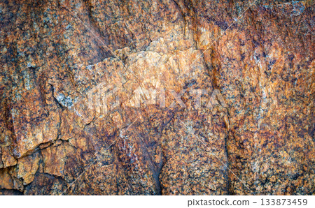 Natural rough stone texture with orange and brown mineral surface Natural rough stone texture with orange and brown mineral surface 133873459