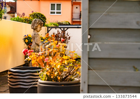 Terrace Garden With Flower Pots And Stone Statue: Sunlit Outdoor Arrangement Of Colorful Blossoms And Decorative Sculpture In Warm Autumn Atmosphere Terrace Garden With Flower Pots And Stone Statue: Sunlit Outdoor Arrangement Of Colorful Blossoms And Decorative Sculpture In Warm Autumn Atmosphere 133873544
