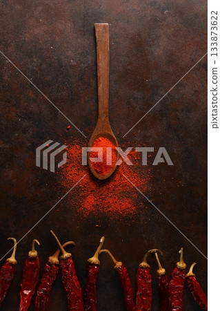 cayenne pepper on wooden spoon spices and dried chilli peppers background. 133873622