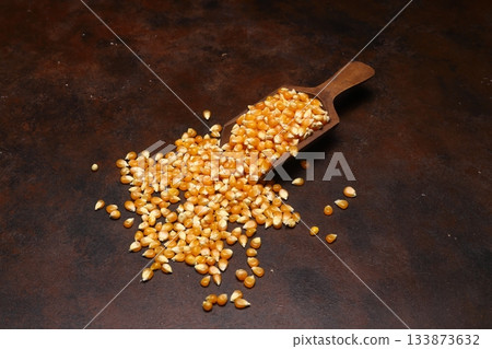 Corn seeds for popcorn isolated on dark rustic background. Copy space 133873632