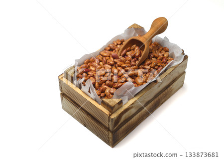 Kidney beans in a small wooden crate, isolated on white background. With wooden spoon. Kidney beans in a small wooden crate, isolated on white background. With wooden spoon. 133873681