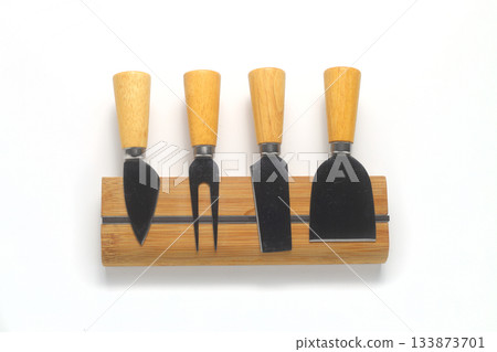 Cheese knives and fork on white background, flat lay Cheese knives and fork on white background, flat lay 133873701