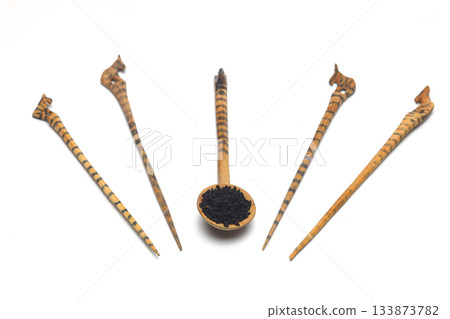 Nigella sativa or Black cumin in wooden spoon isolated on white background 133873782