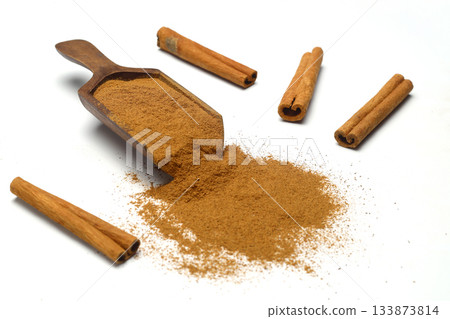 Wood scoop with cinnamon powder and cinnamon sticks isolated on white background Wood scoop with cinnamon powder and cinnamon sticks isolated on white background 133873814