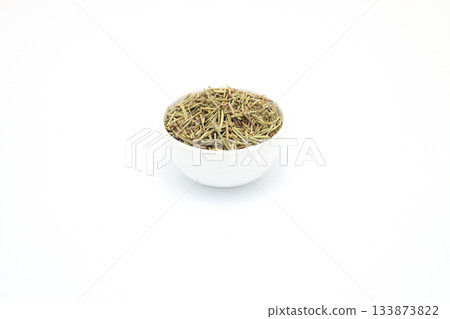 Chopped rosemary in a bowl isolated on white background with copy space for text or images. Chopped rosemary in a bowl isolated on white background with copy space for text or images. 133873822