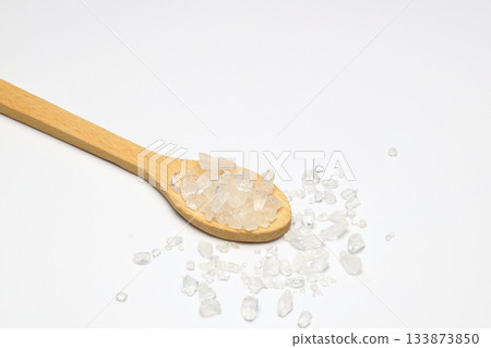 sea salt in a spoon isolated on white background 133873850