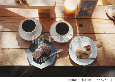 coffee and cake on a cafe table coffee and cake on a cafe table 133873885
