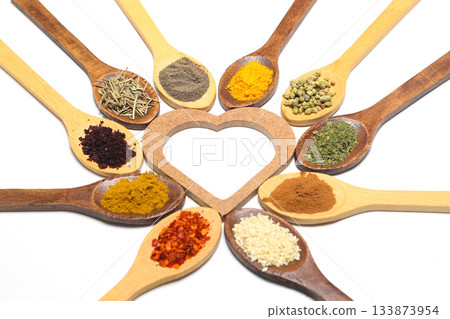 Different kind of spices on a white background. Oriental spices in spoons, red peppers, curry powder, cinnamon powder, mint powder, sumac, sesame, black cumin, Different kind of spices on a white background. Oriental spices in spoons, red peppers, curry powder, cinnamon powder, mint powder, sumac, sesame, black cumin, 133873954