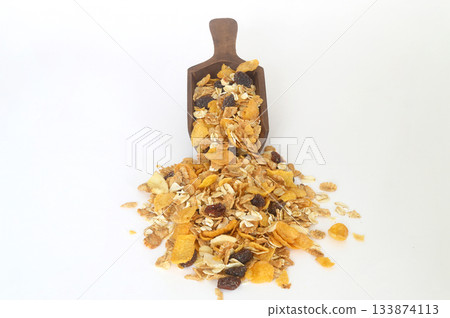Healthy cereal breakfast. Mixed muesli in wooden scoop isolated on white background. Healthy cereal breakfast. Mixed muesli in wooden scoop isolated on white background. 133874113