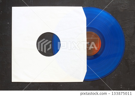 Aged black paper cover and vinyl LP record isolated on black background 133875011
