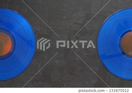 Blue Vinyl record on a black background. Retro style. Top view. Blue Vinyl record on a black background. Retro style. Top view. 133875012