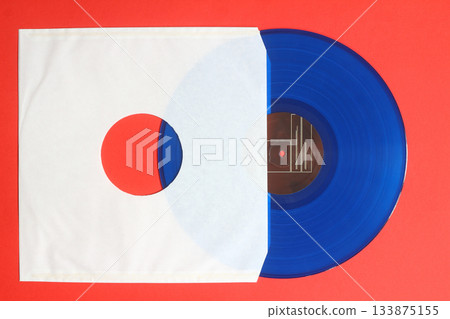 Aged White paper cover and blue vinyl LP record isolated on Red background Aged White paper cover and blue vinyl LP record isolated on Red background 133875155