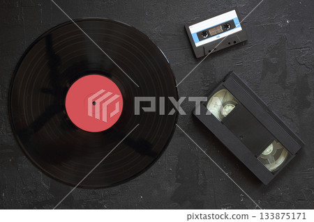 Vinyl record, audio and video cassettes top view 133875171